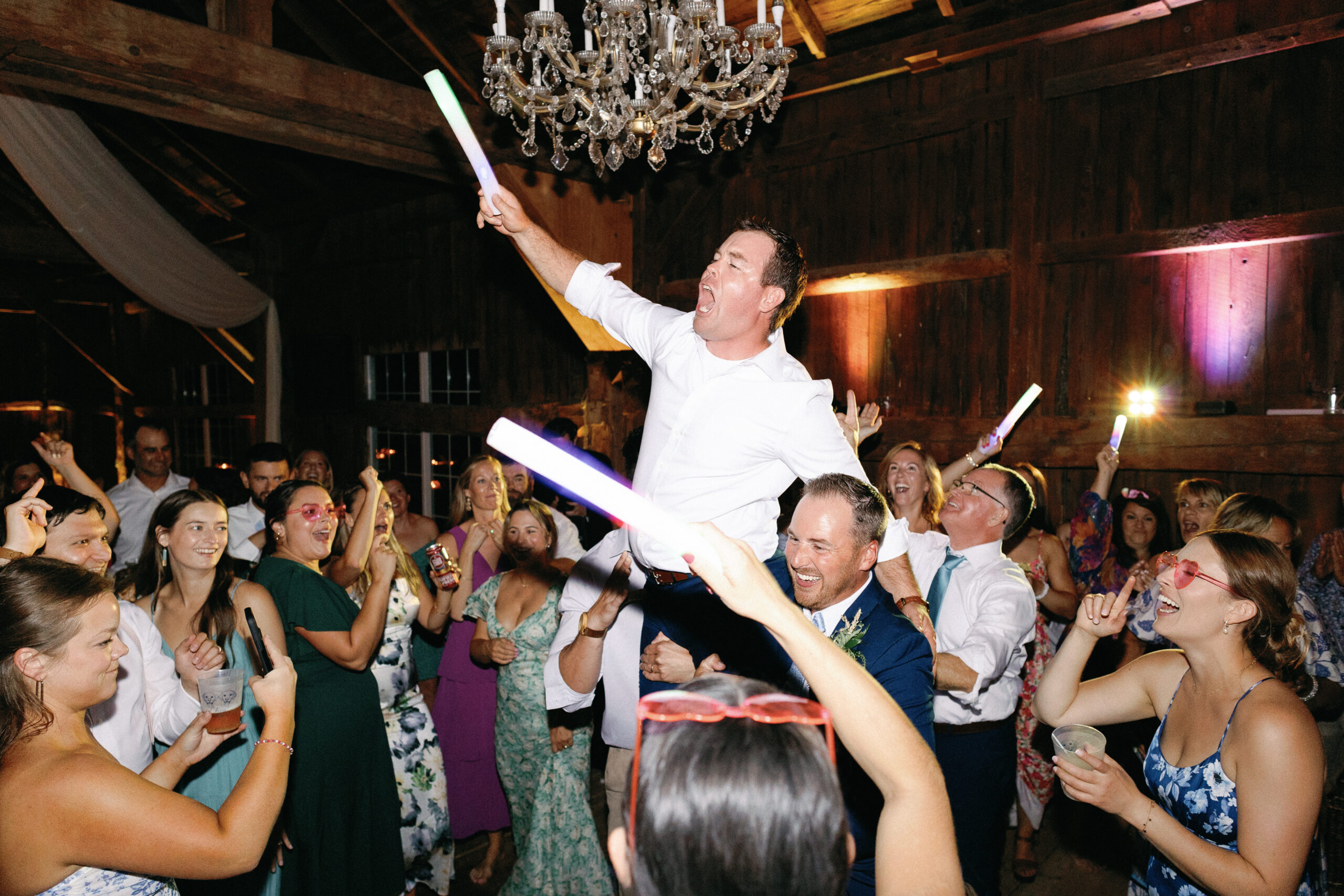 High energy wedding DJ entertainment creating a packed dance floor